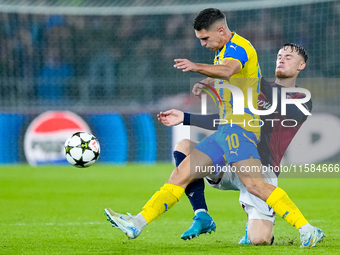 Sam Beukema of Bologna FC and Heorhiy Sudakov of FC Shakhtar Donetsk compete for the ball during the UEFA Champions League 2024/25 League Ph...