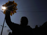 Mitzi Ortega Padron, a native of the Tlahuac municipality in Mexico City, cuts squash blossoms on a plot of land located on the limits of th...