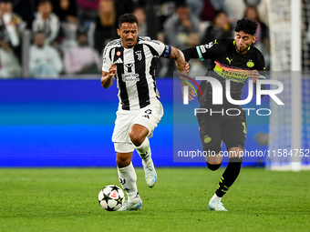 Danilo of Juventus fights for the ball with Ricardo Pepi of PSV during the UEFA Champions League 2024/25 League Phase MD1 match between Juve...