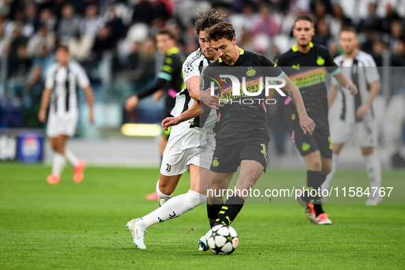 Dusan Vlahovic of Juventus fights for the ball with Oliviero Boscagli of PSV during the UEFA Champions League 2024/25 League Phase MD1 match...