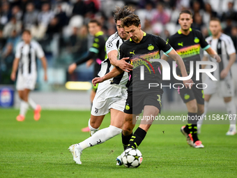 Dusan Vlahovic of Juventus fights for the ball with Oliviero Boscagli of PSV during the UEFA Champions League 2024/25 League Phase MD1 match...