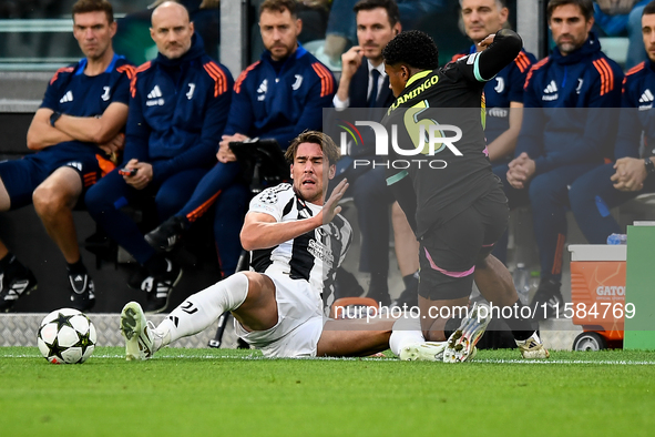 Dusan Vlahovic of Juventus fights for the ball with Ryan Flamingo of PSV during the UEFA Champions League 2024/25 League Phase MD1 match bet...