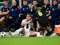 Dusan Vlahovic of Juventus fights for the ball with Ryan Flamingo of PSV during the UEFA Champions League 2024/25 League Phase MD1 match bet...