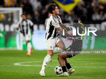 Dusan Vlahovic of Juventus contends for the ball with Ryan Flamingo of PSV during the UEFA Champions League 2024/25 League Phase MD1 match b...