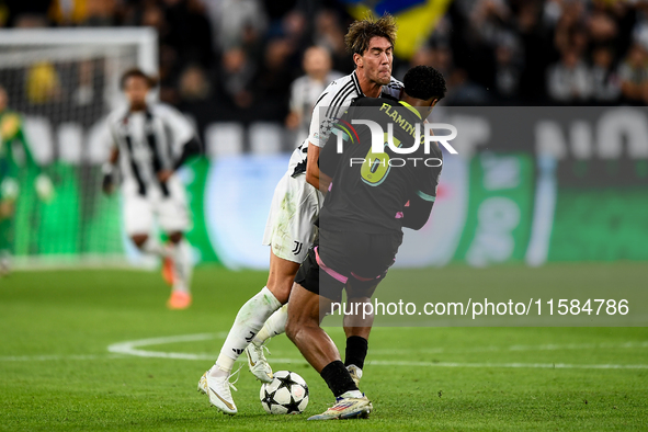 Dusan Vlahovic of Juventus contends for the ball with Ryan Flamingo of PSV during the UEFA Champions League 2024/25 League Phase MD1 match b...