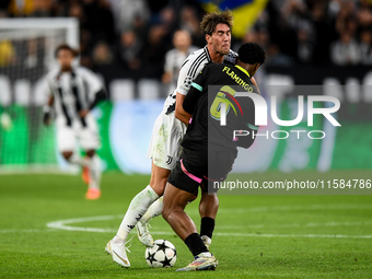 Dusan Vlahovic of Juventus contends for the ball with Ryan Flamingo of PSV during the UEFA Champions League 2024/25 League Phase MD1 match b...