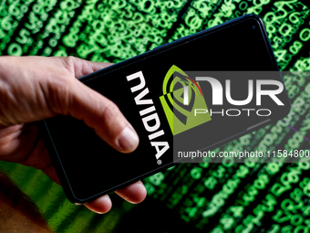 In this photo illustration, the Nvidia logo is seen displayed on a smartphone screen against a computer screen displaying a matrix image, as...