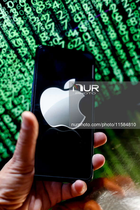 In this photo illustration, the Nvidia logo is seen displayed on a smartphone screen against a computer screen displaying a matrix image, as...