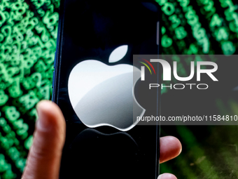 In this photo illustration, the Nvidia logo is seen displayed on a smartphone screen against a computer screen displaying a matrix image, as...