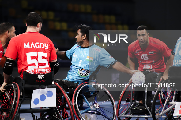 India's player passes the ball to his teammate during their match against Egypt at the World Wheelchair Handball Championship in Egypt, on S...