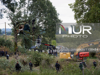 Access to the trees where the 'Ecureuil' (Squirrel) lives is blocked by policemen as workers from NGE wait to begin the destruction of the '...