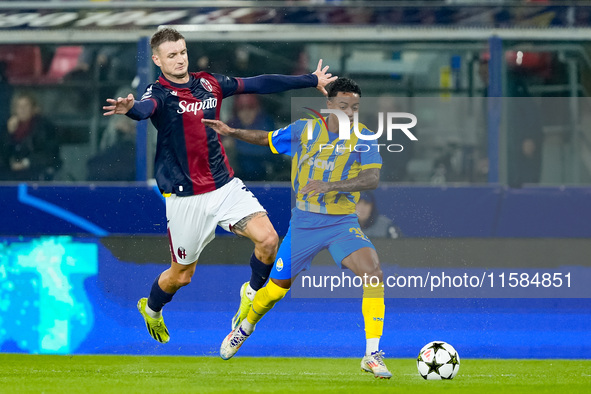 Newerton of FC Shakhtar Donetsk and Stefan Posch of Bologna FC compete for the ball during the UEFA Champions League 2024/25 League Phase MD...