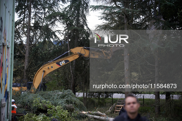 A Gendarme stands guard as an excavator destroys trees at the 'Verger' ZAD. For the second day, Gendarmerie and CNAMO try to dislodge 'Ecure...