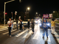 Israeli protesters block Herzog Street in West Jerusalem, near Prime Minister Netanyahu's residence, calling for an end to the war and the i...