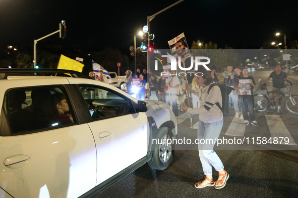 Israeli protesters block Herzog Street in West Jerusalem, near Prime Minister Netanyahu's residence, calling for an end to the war and the i...