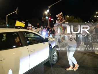 Israeli protesters block Herzog Street in West Jerusalem, near Prime Minister Netanyahu's residence, calling for an end to the war and the i...