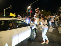 Israeli protesters block Herzog Street in West Jerusalem, near Prime Minister Netanyahu's residence, calling for an end to the war and the i...