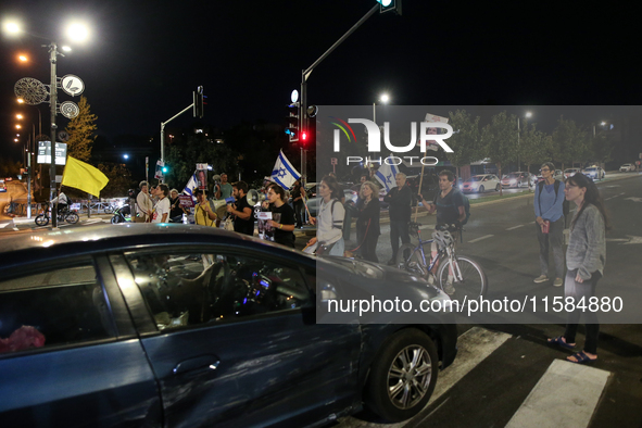 Israeli protesters block Herzog Street in West Jerusalem, near Prime Minister Netanyahu's residence, calling for an end to the war and the i...