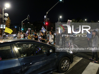 Israeli protesters block Herzog Street in West Jerusalem, near Prime Minister Netanyahu's residence, calling for an end to the war and the i...