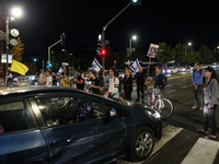 Israeli protesters block Herzog Street in West Jerusalem, near Prime Minister Netanyahu's residence, calling for an end to the war and the i...