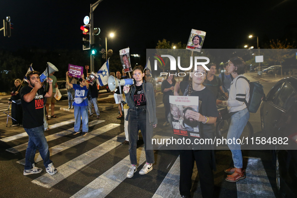 Israeli protesters block Herzog Street in West Jerusalem, near Prime Minister Netanyahu's residence, calling for an end to the war and the i...