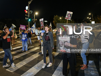 Israeli protesters block Herzog Street in West Jerusalem, near Prime Minister Netanyahu's residence, calling for an end to the war and the i...