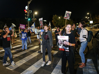 Israeli protesters block Herzog Street in West Jerusalem, near Prime Minister Netanyahu's residence, calling for an end to the war and the i...