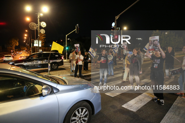 Israeli protesters block Herzog Street in West Jerusalem, near Prime Minister Netanyahu's residence, calling for an end to the war and the i...