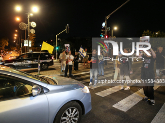 Israeli protesters block Herzog Street in West Jerusalem, near Prime Minister Netanyahu's residence, calling for an end to the war and the i...