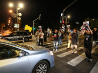 Israeli protesters block Herzog Street in West Jerusalem, near Prime Minister Netanyahu's residence, calling for an end to the war and the i...