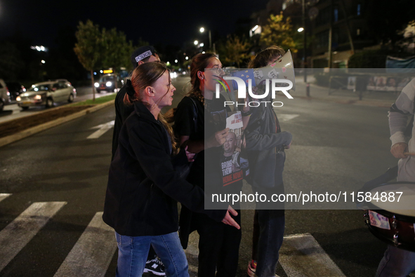 Israeli protesters block Herzog Street in West Jerusalem, near Prime Minister Netanyahu's residence, calling for an end to the war and the i...