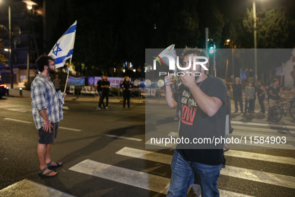 Israeli protesters block Herzog Street in West Jerusalem, near Prime Minister Netanyahu's residence, calling for an end to the war and the i...