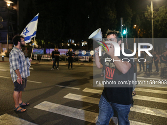 Israeli protesters block Herzog Street in West Jerusalem, near Prime Minister Netanyahu's residence, calling for an end to the war and the i...