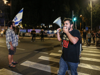 Israeli protesters block Herzog Street in West Jerusalem, near Prime Minister Netanyahu's residence, calling for an end to the war and the i...