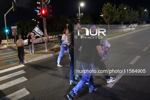 Israeli protesters block Herzog Street in West Jerusalem, near Prime Minister Netanyahu's residence, calling for an end to the war and the i...