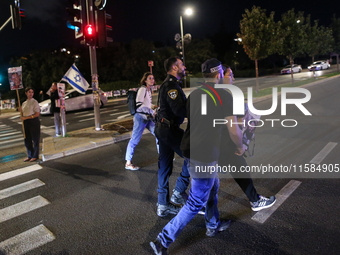 Israeli protesters block Herzog Street in West Jerusalem, near Prime Minister Netanyahu's residence, calling for an end to the war and the i...