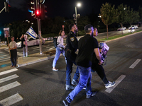 Israeli protesters block Herzog Street in West Jerusalem, near Prime Minister Netanyahu's residence, calling for an end to the war and the i...