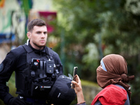 A protester blocked by a Gendarme films the destruction of a tree by an excavator driver. For the second day, the Gendarmerie and CNAMO try...