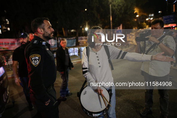 Israeli protesters block Herzog Street in West Jerusalem, near Prime Minister Netanyahu's residence, calling for an end to the war and the i...