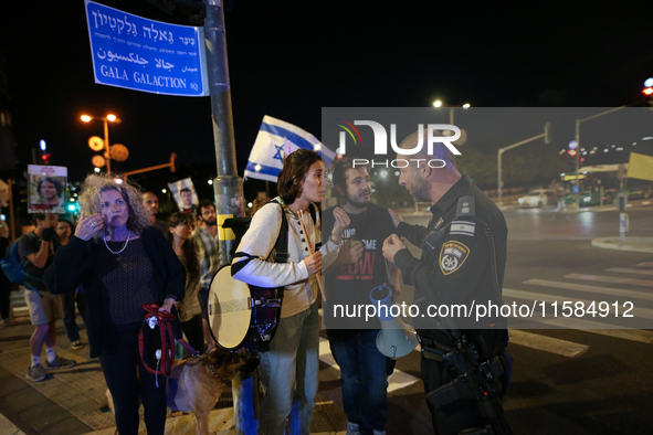 Israeli protesters block Herzog Street in West Jerusalem, near Prime Minister Netanyahu's residence, calling for an end to the war and the i...