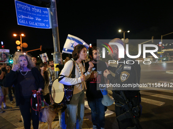 Israeli protesters block Herzog Street in West Jerusalem, near Prime Minister Netanyahu's residence, calling for an end to the war and the i...