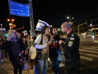 Israeli protesters block Herzog Street in West Jerusalem, near Prime Minister Netanyahu's residence, calling for an end to the war and the i...