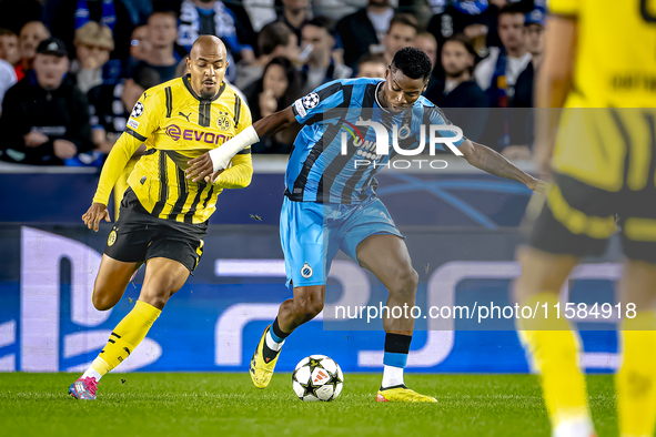 Borussia Dortmund forward Donyell Malen and Club Brugge midfielder Raphael Onyedika during the match between Club Brugge and Borussia Dortmu...