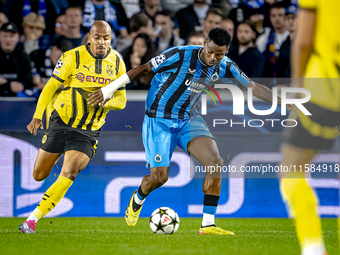 Borussia Dortmund forward Donyell Malen and Club Brugge midfielder Raphael Onyedika during the match between Club Brugge and Borussia Dortmu...