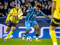 Borussia Dortmund forward Donyell Malen and Club Brugge midfielder Raphael Onyedika during the match between Club Brugge and Borussia Dortmu...