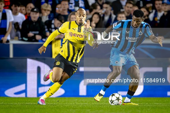 Borussia Dortmund forward Donyell Malen and Club Brugge midfielder Raphael Onyedika during the match between Club Brugge and Borussia Dortmu...