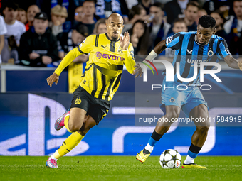 Borussia Dortmund forward Donyell Malen and Club Brugge midfielder Raphael Onyedika during the match between Club Brugge and Borussia Dortmu...