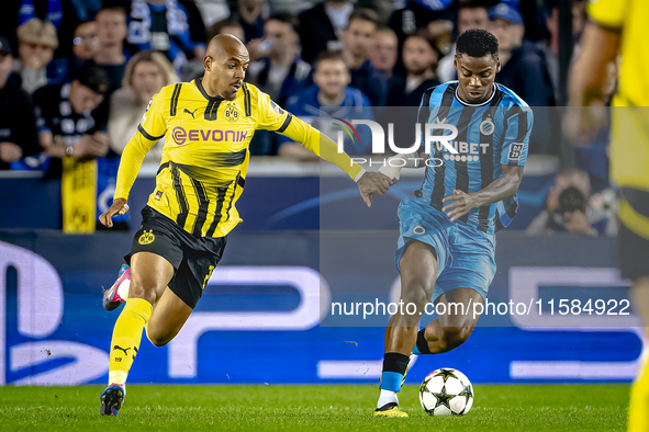 Borussia Dortmund forward Donyell Malen and Club Brugge midfielder Raphael Onyedika during the match between Club Brugge and Borussia Dortmu...