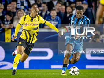 Borussia Dortmund forward Donyell Malen and Club Brugge midfielder Raphael Onyedika during the match between Club Brugge and Borussia Dortmu...