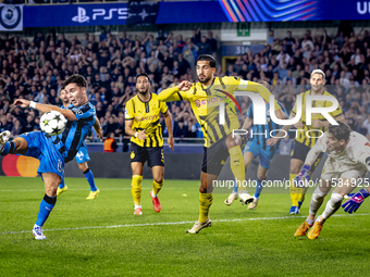 Club Brugge midfielder Hugo Vetlesen, Borussia Dortmund defender Emre Can, and Borussia Dortmund goalkeeper Gregor Kobel during the match be...